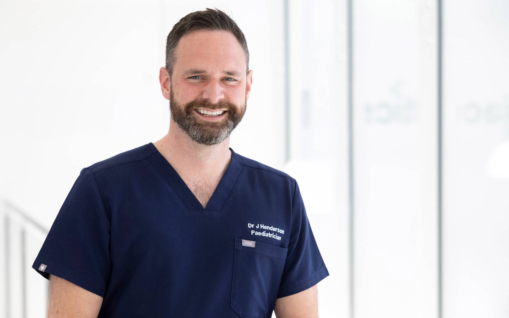 Dr Henderson navy tunic smiling Dr Henderson wearing a navy tunic and smiling